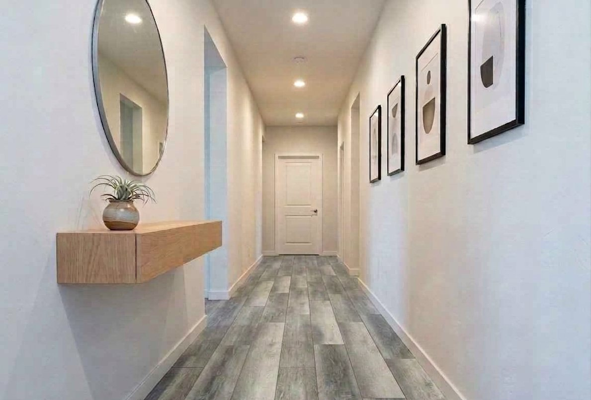 Gray wood-look LVP flooring installation in a hallway